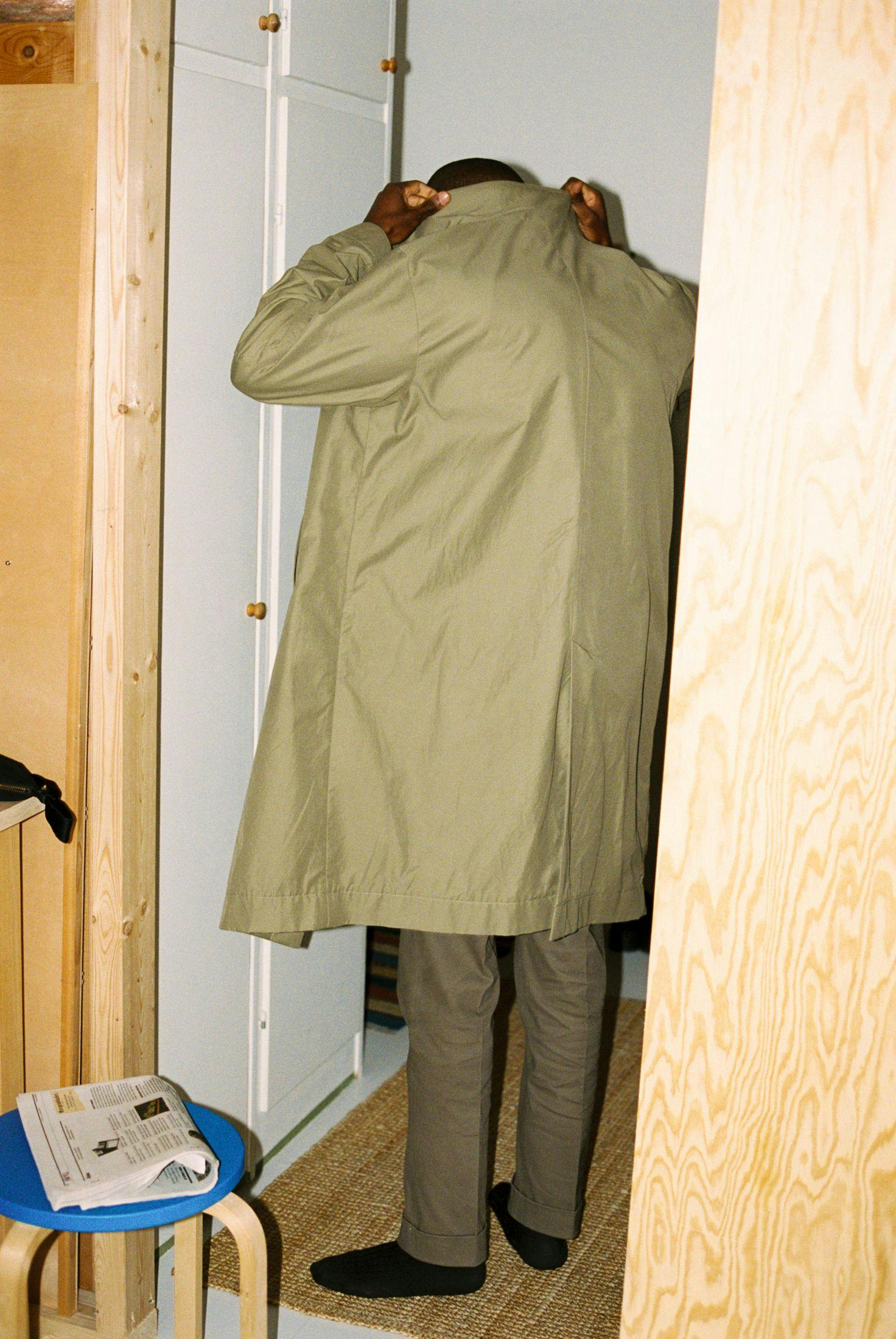 Man in a coat in the hallway